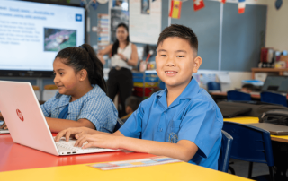Two students from Immaculate Heart of Mary Catholic Primary School in Sefton enjoying a lesson in the classroom
